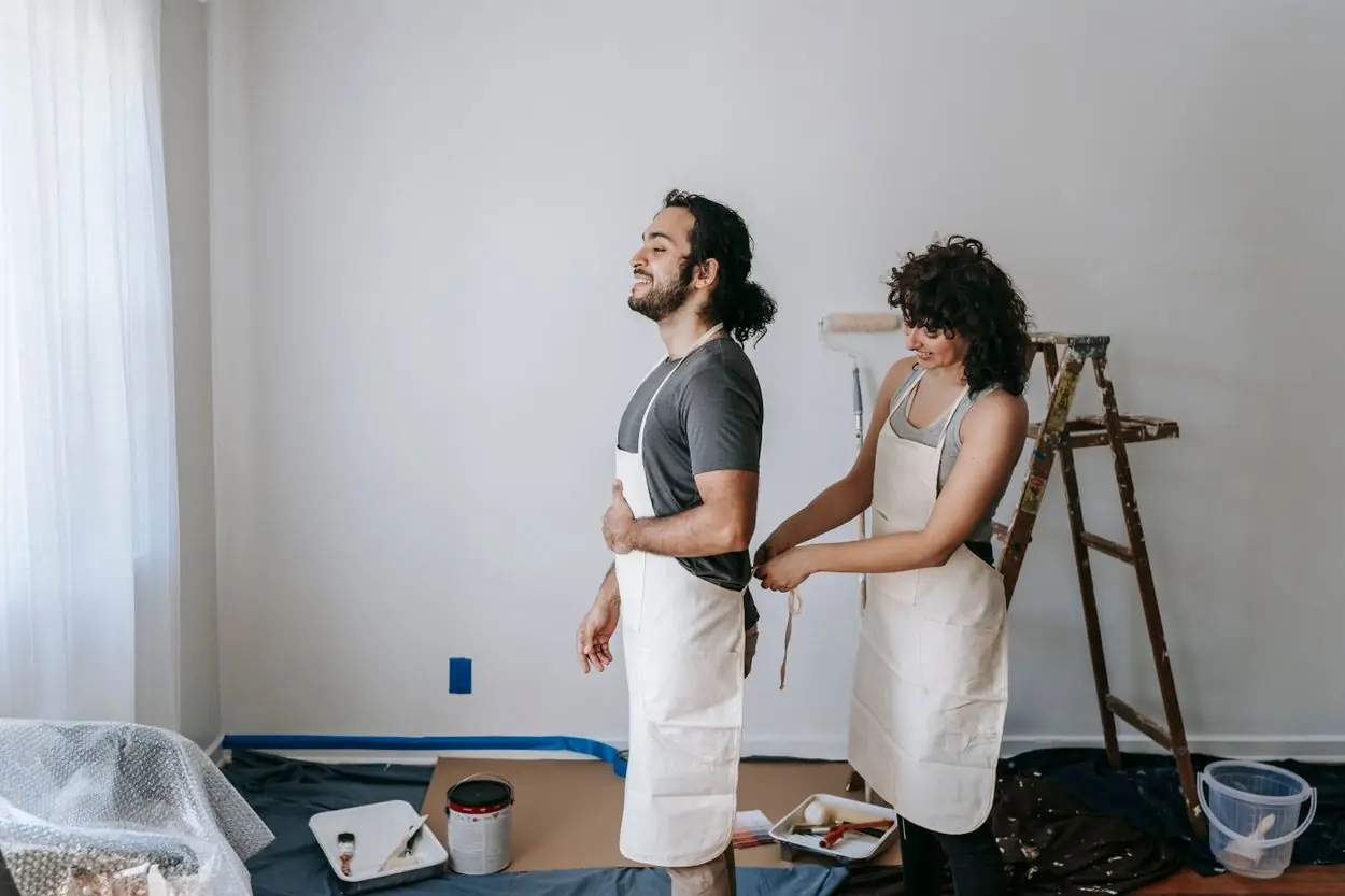 Illustrative lifestyle photograph of a diverse couple preparing to renovate their home